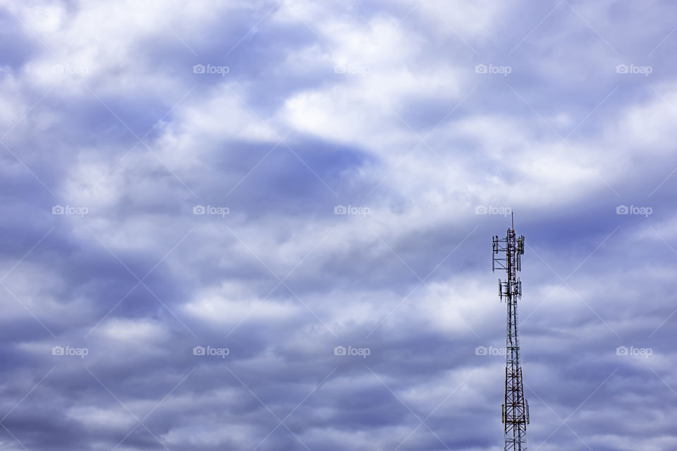 Wave transmission mast, large phone signal with a bright blue sky.