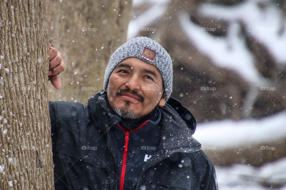 Man with beard is hiking outdoors in winter