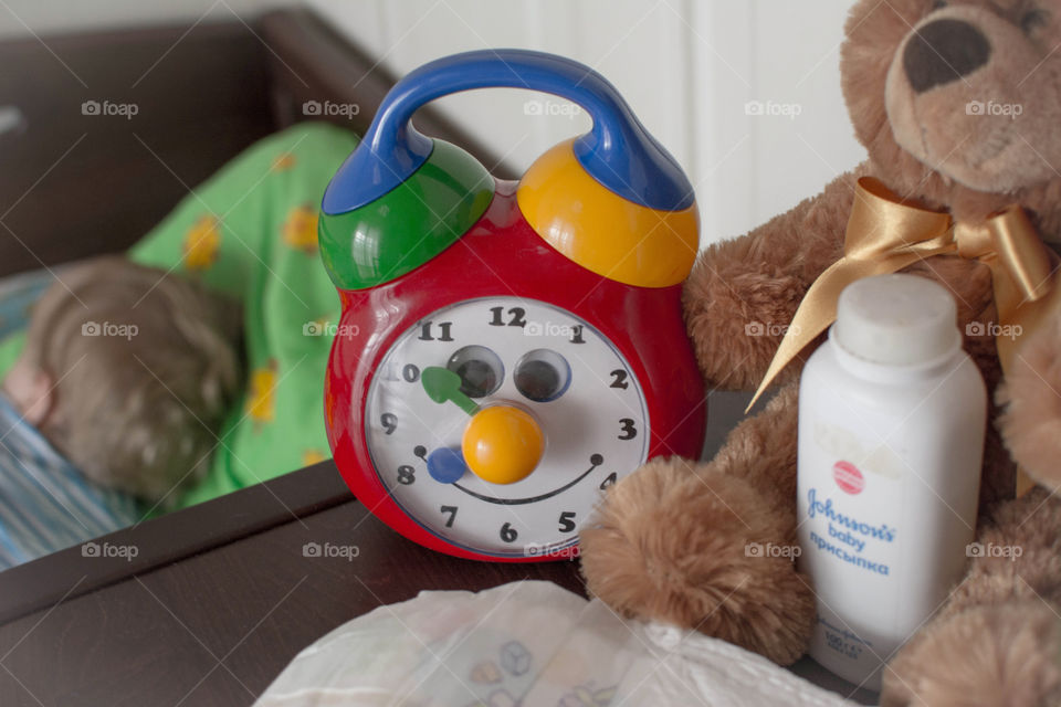 the first minutes of mum's day. funny clock and sleeping baby