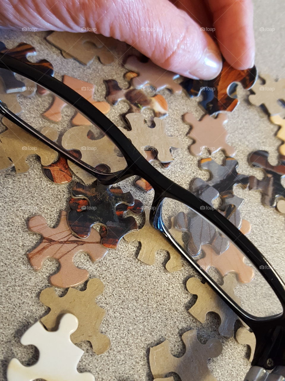 Close-up of eyeglass and puzzle piece