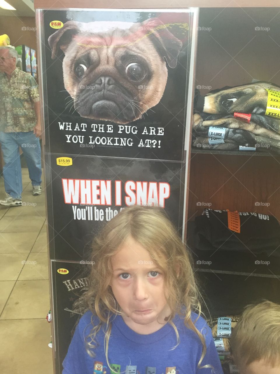 Small girl standing near poster