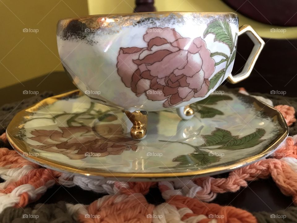 3 footed iridescent fine bone China cup with pink roses and gold trim. 