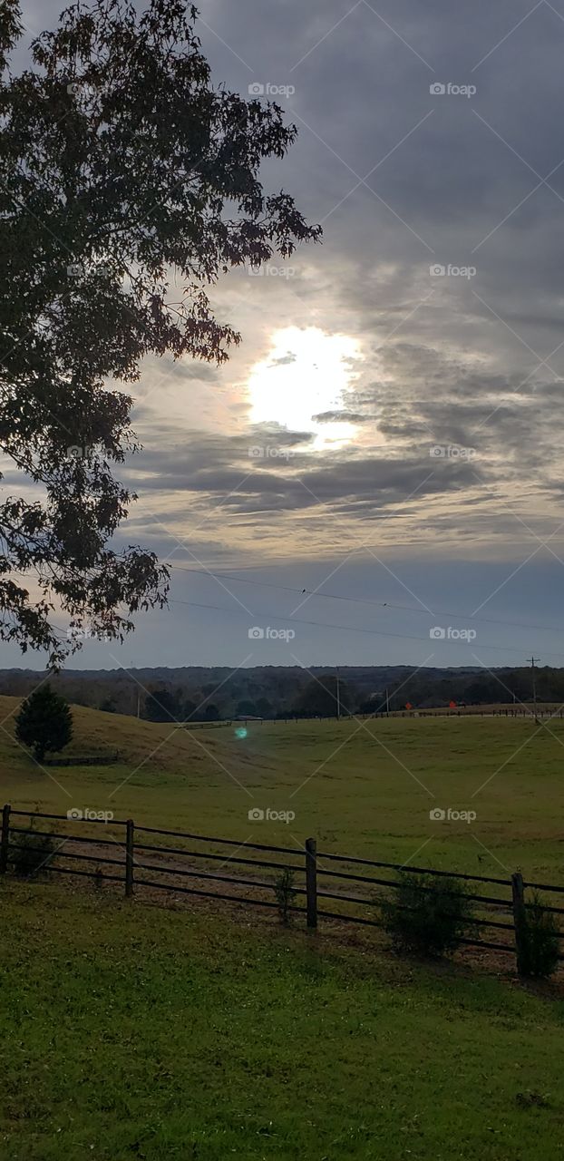 closer look at the sunset over the farm