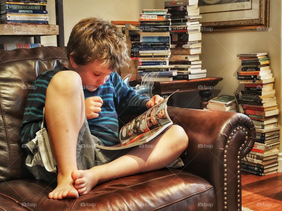 Young Reader Surrounded By Stacks Of Books. Childhood Literacy
