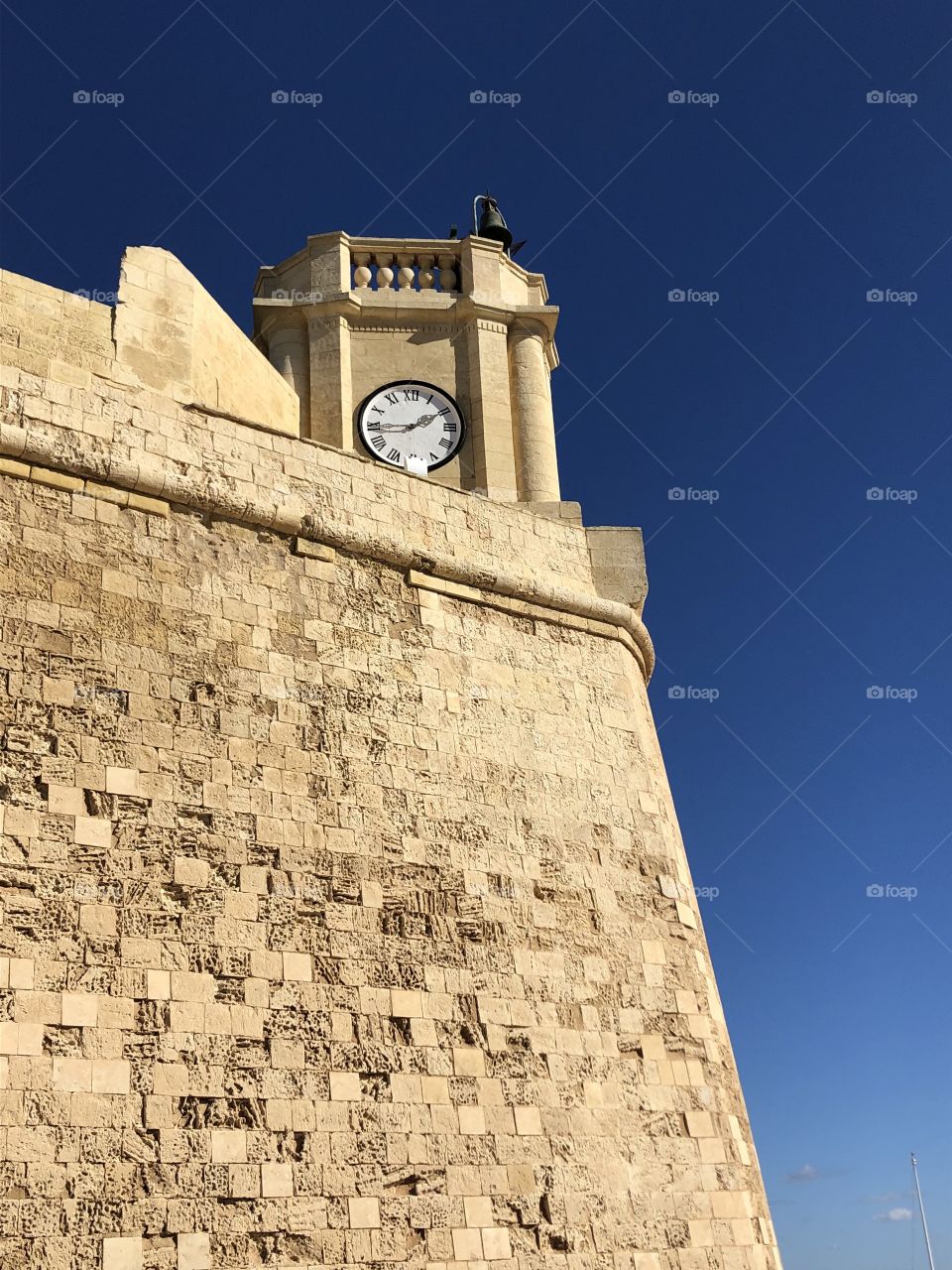 One picture of the clock tower of the Citadel in the sunny and warm Victoria, Gozo (an island just off the cost of Malta). 