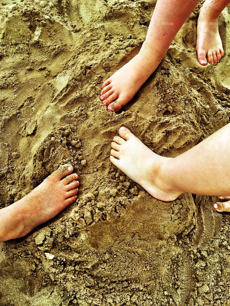 Children making their footprints at the beach