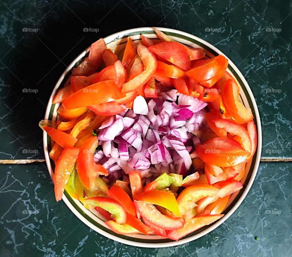 Bowl of tomatoes with onions
