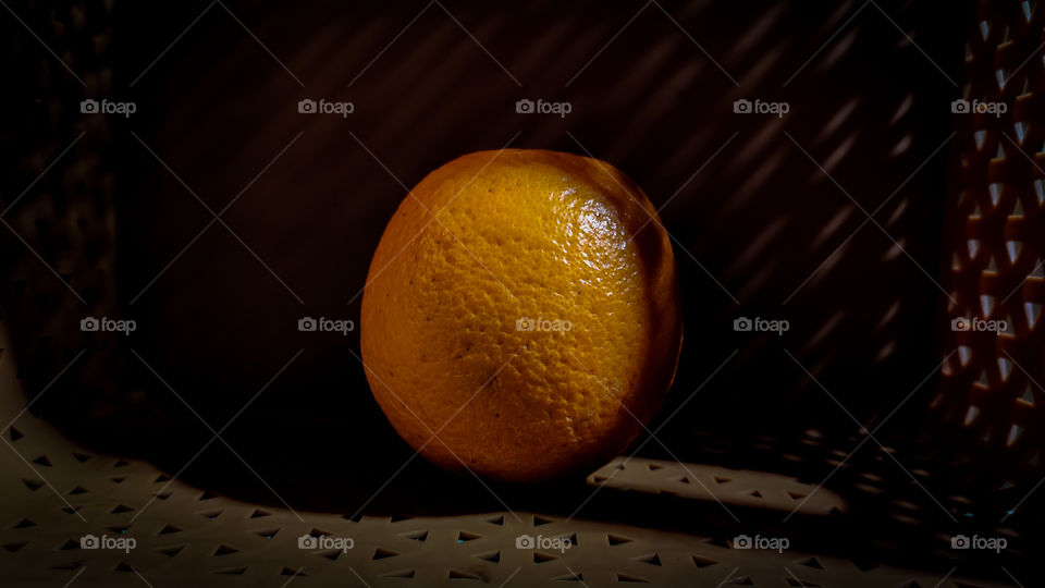 orange in the dark with shadow lighting.