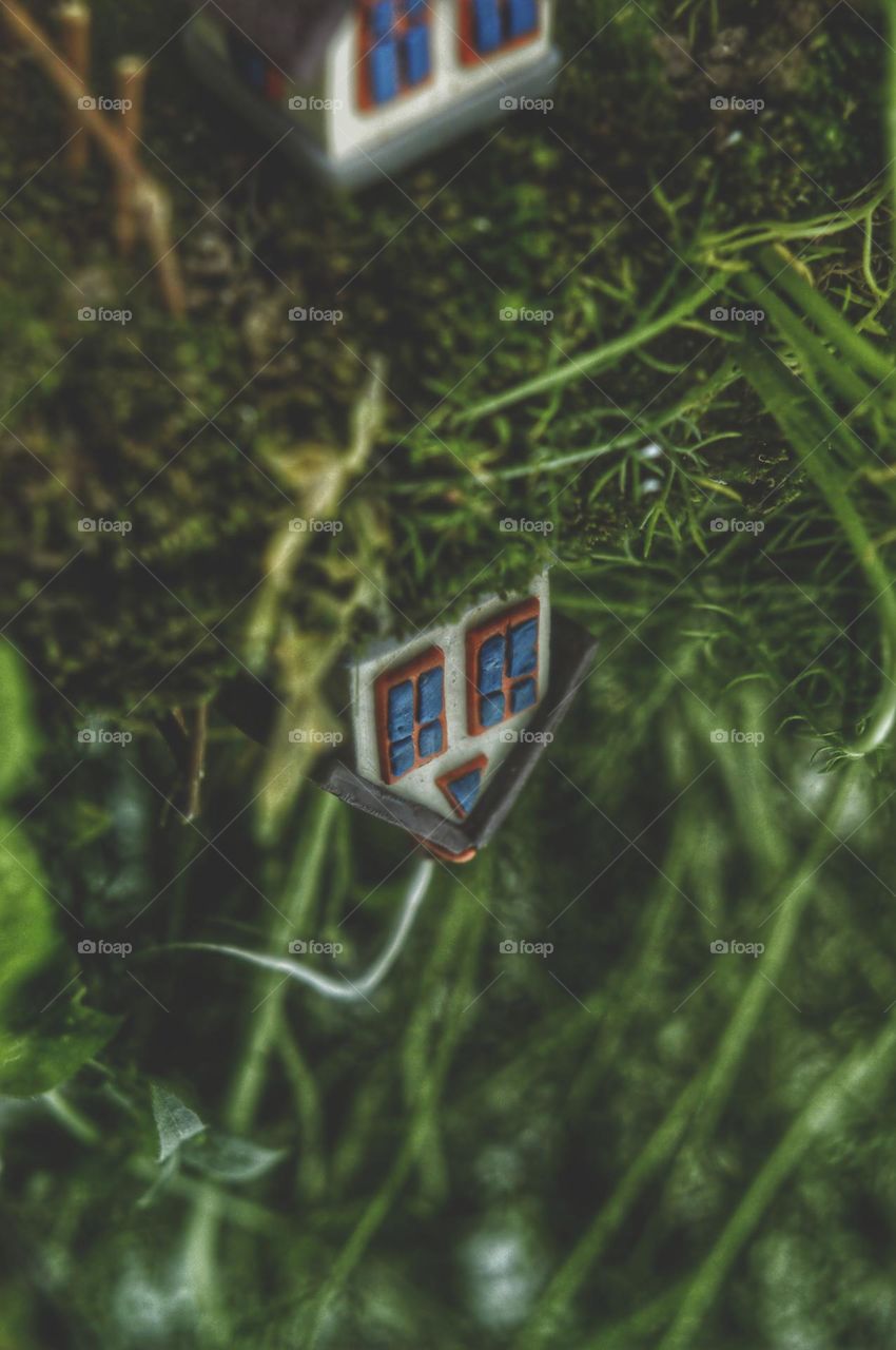 the house is reflected in the lake or mirror. plasticine house molded.