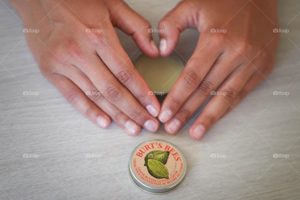 Woman's hands with Burt's bees product