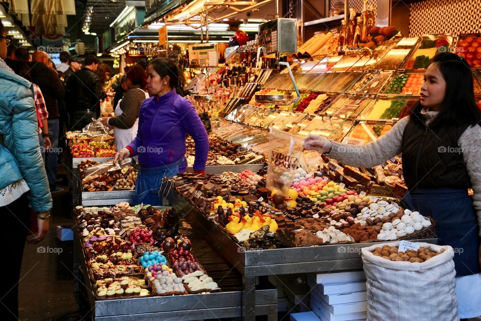 Market in Barcelona, Spain. Sellers offer sweets and candy 