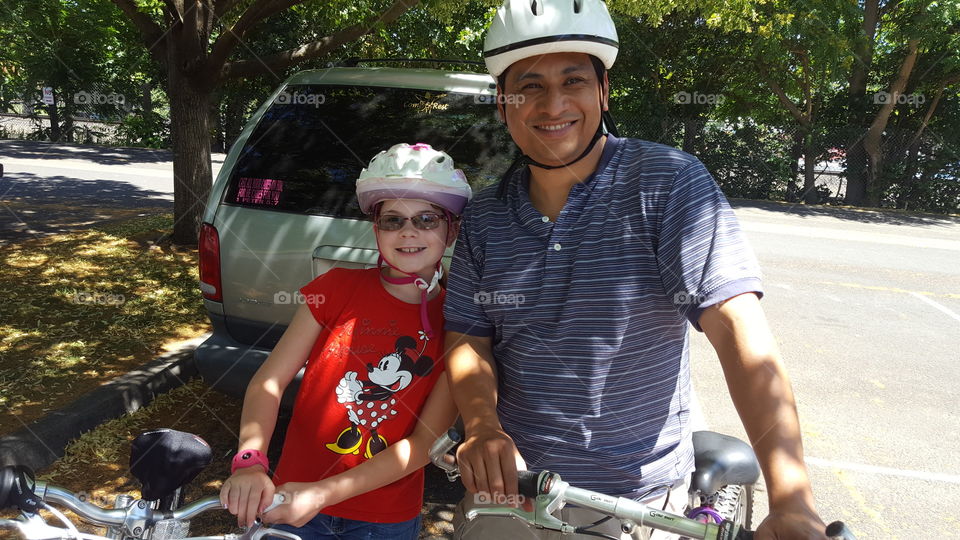 Portrait of father and daughter with bicycle