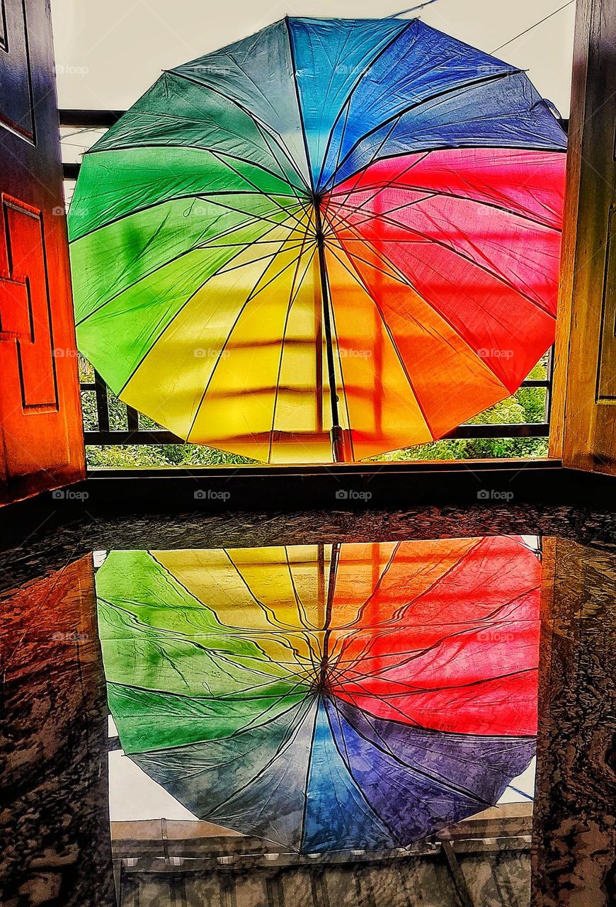 The reflection of a colorful umbrella π on a glossy marble floor. It's really difficult to capture such a photo πΈ. This photo may be used for several business purposes.