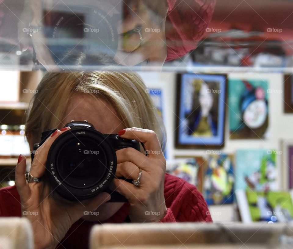 Selfie in a mirror at an art display