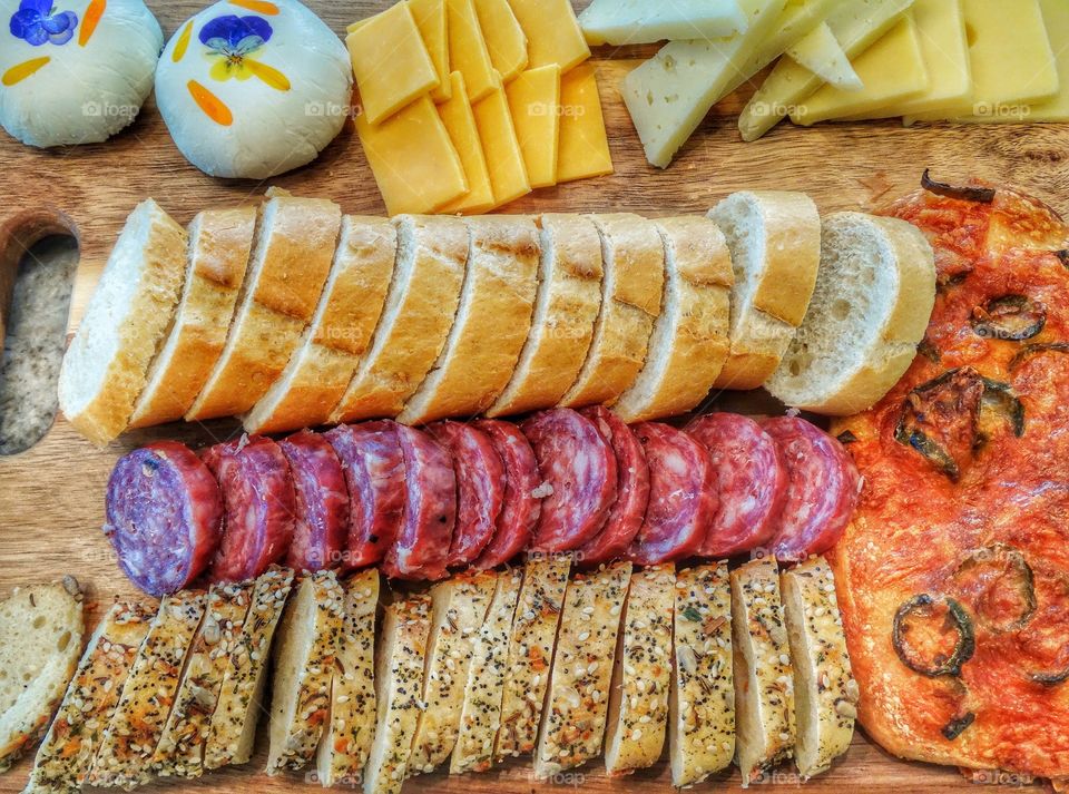 Bread, meats, and cheese ready for a picnic
