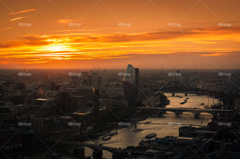 Autumn sunset over London with view at the busy Thames River with bridges. London. UK.