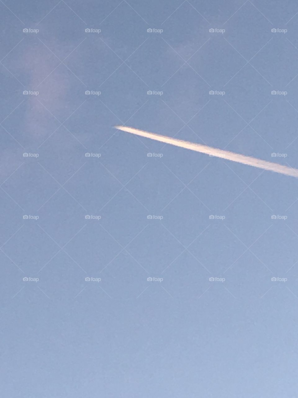 Jet flying over into a clear blue sky picture perfect day for flying high in the sky!