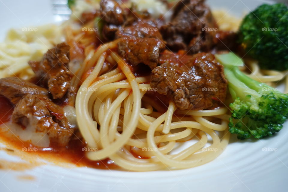 Close-up of tomato sauce pasta with beef.