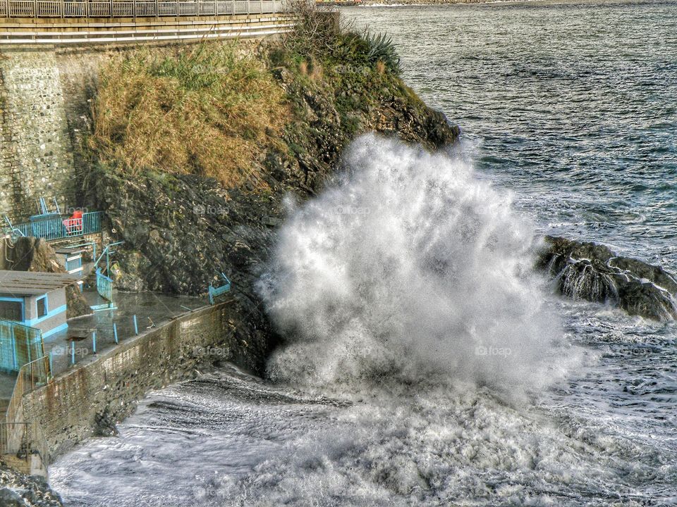 Sea waves crashing on cliff