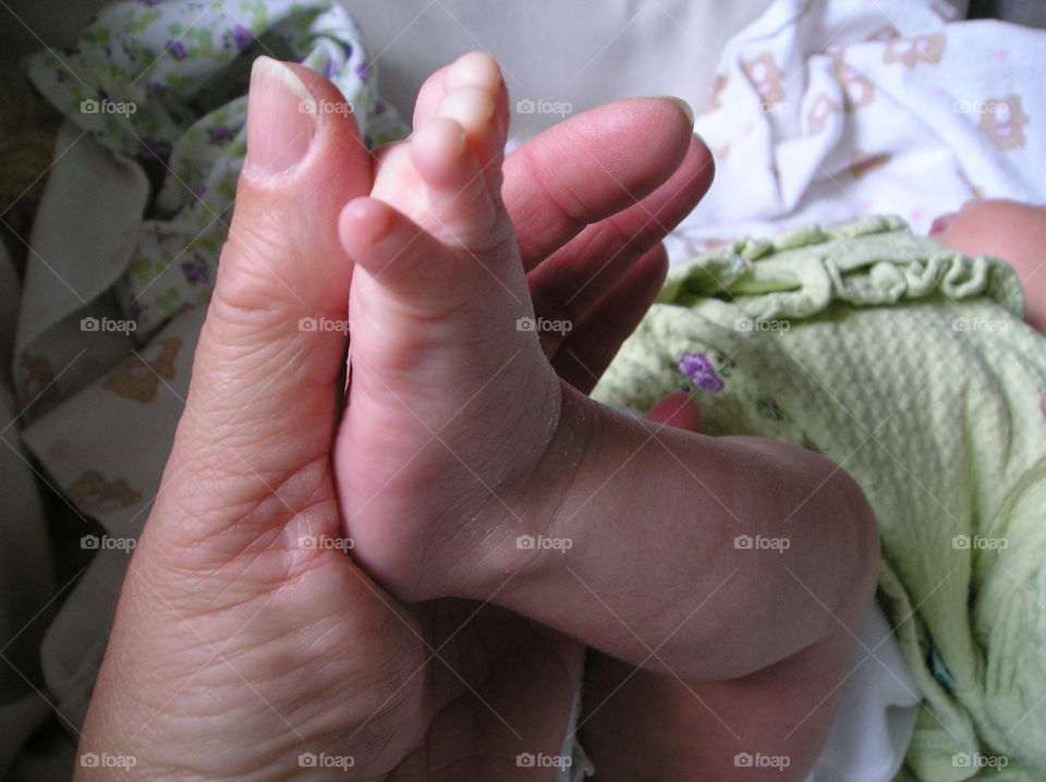 Babies tiny precious foot is the same length as her Momma’s thumb!
