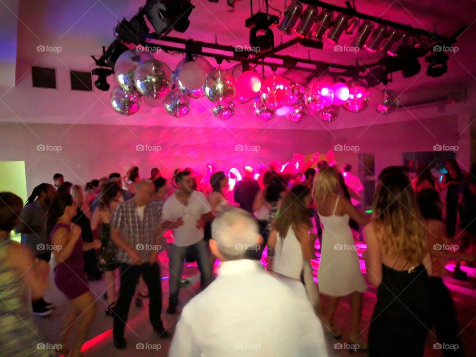 many people at a night club dancing