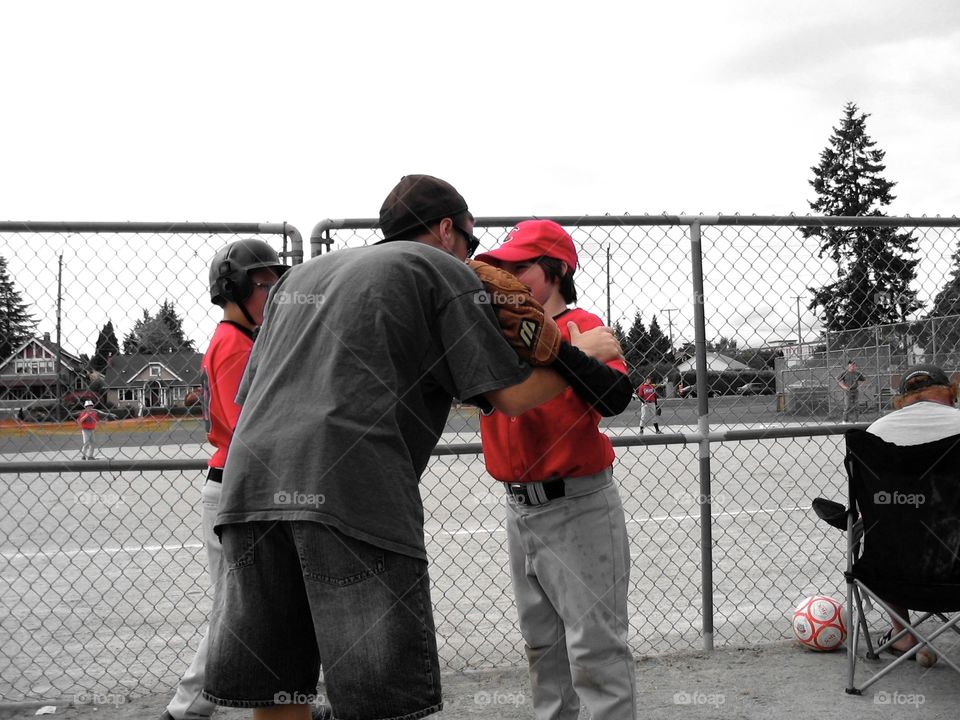 Coach and little leaguer. Coach having a word with little leaguer