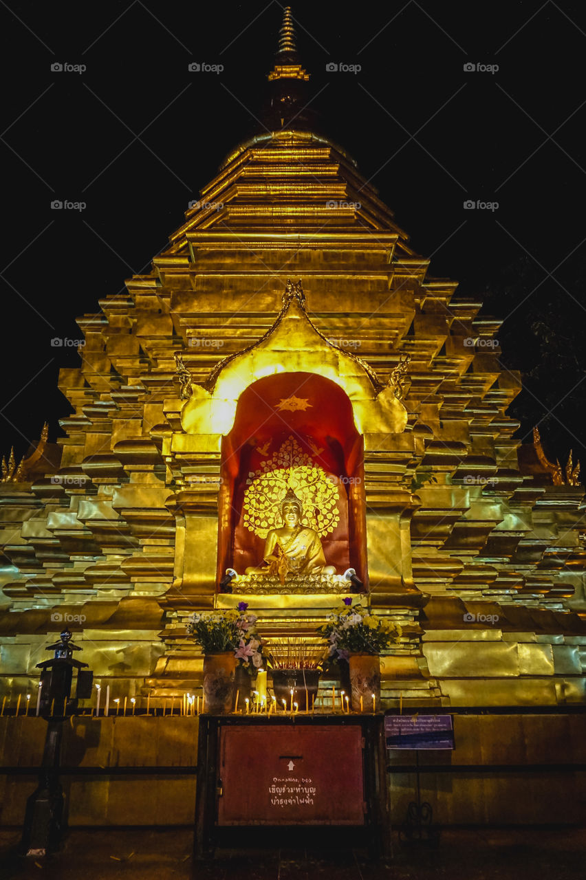 Golden Buddha and geometric stupa in Chiang Mai, Thailand 