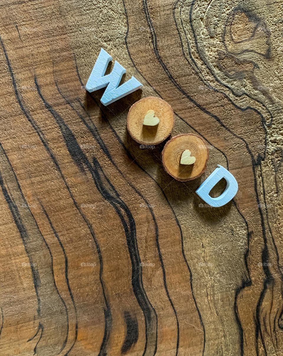 The word “wood” spelled out in wooden letters against a wood background 