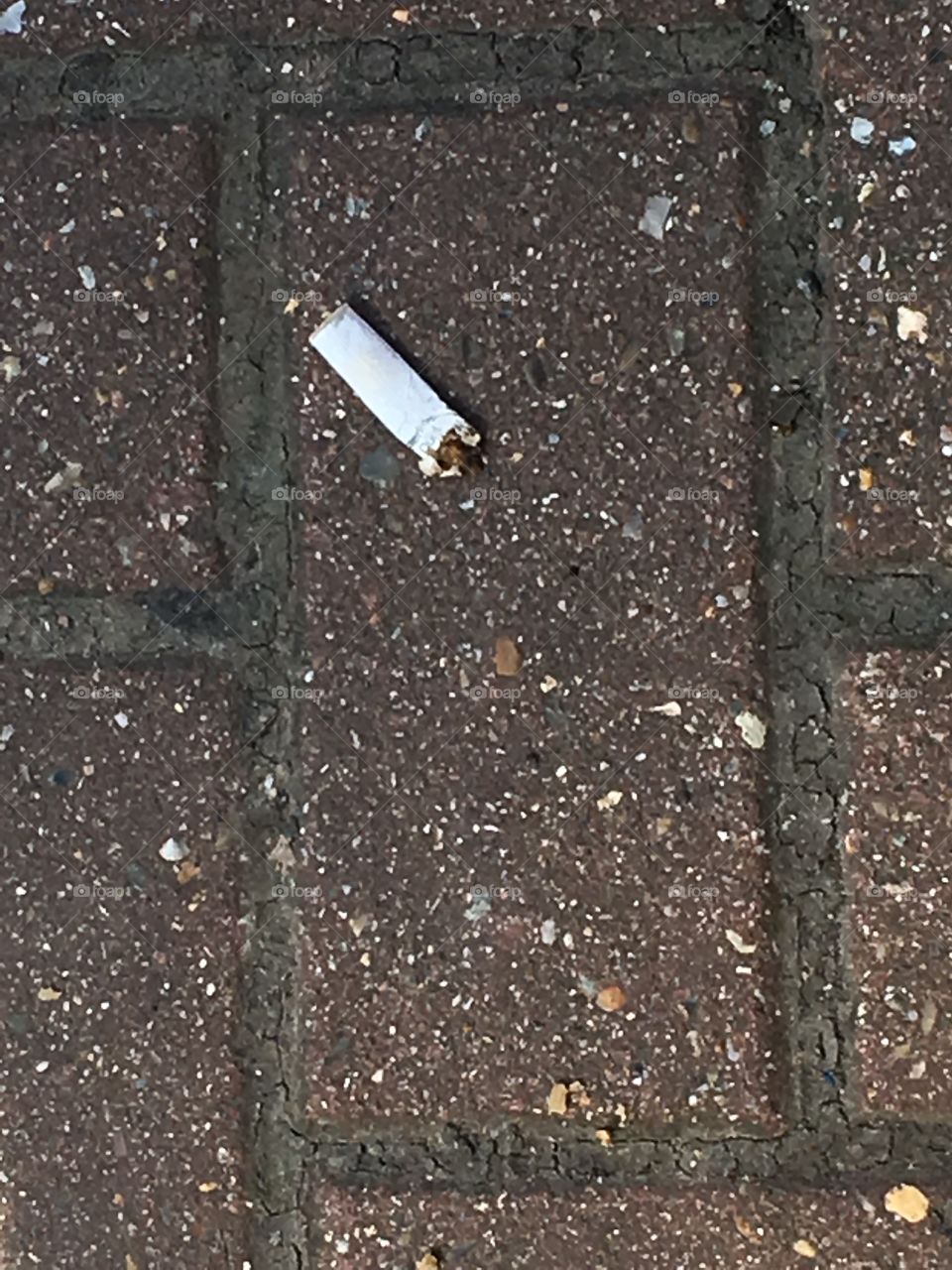 Cigarette butt on floor.