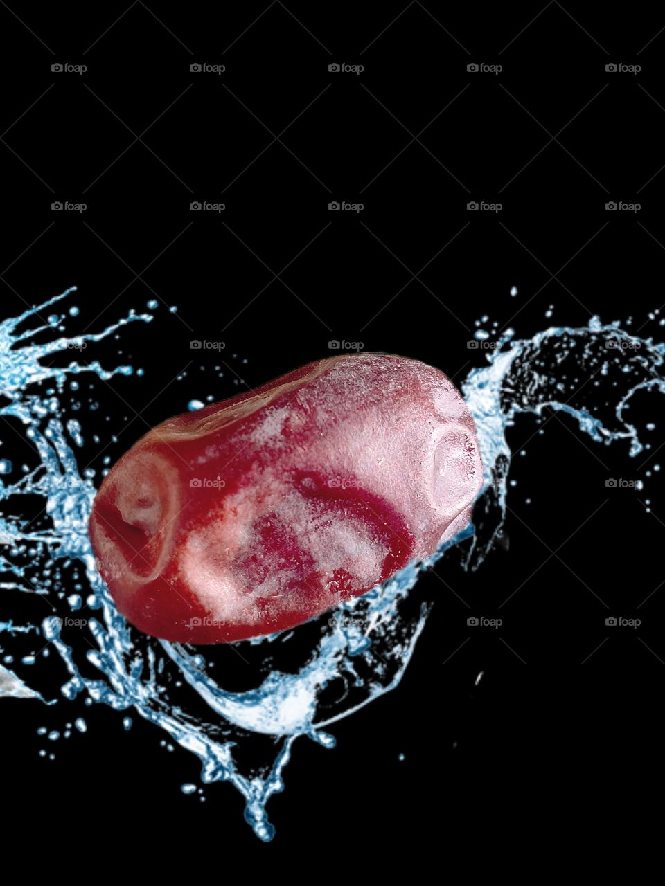 Date fruit in water splash on black background