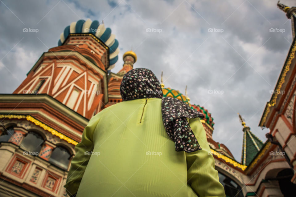 Modest Muslim girl looking at Saint Basil's architecture