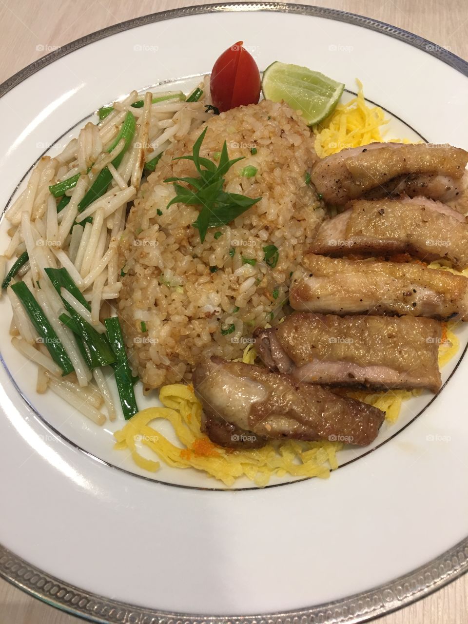 Fried rice with crispy chicken served with stir sprout.