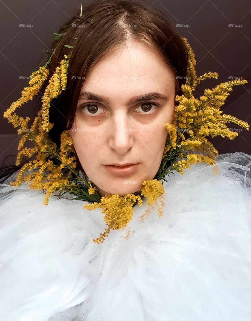 Portrait of a girl with yellow flowers