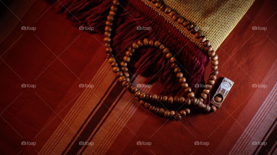 Wooden prayer beads on a prayer mat