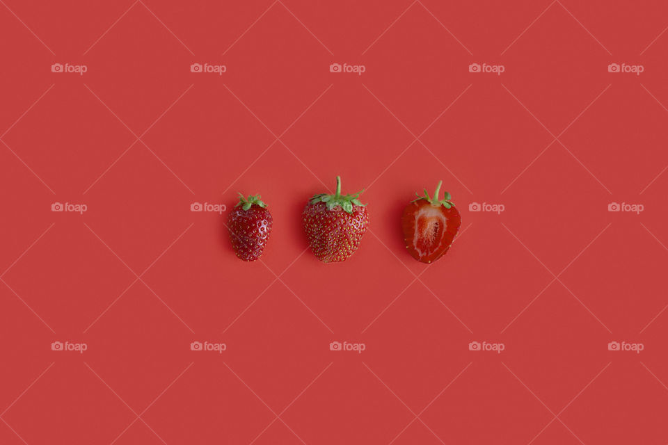 Red on red. Strawberry on a red background 