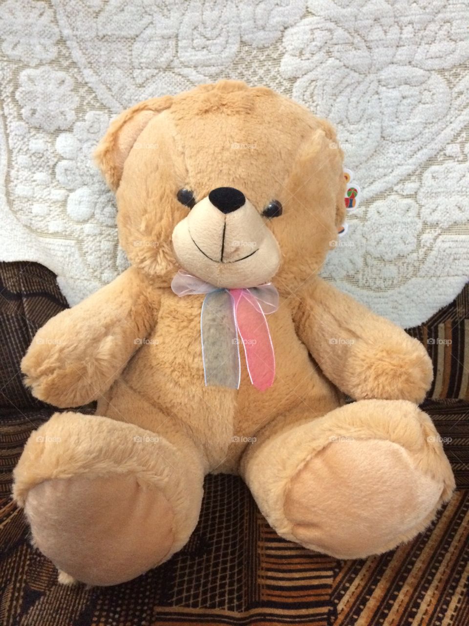 teddy bear toy sitting in sofa