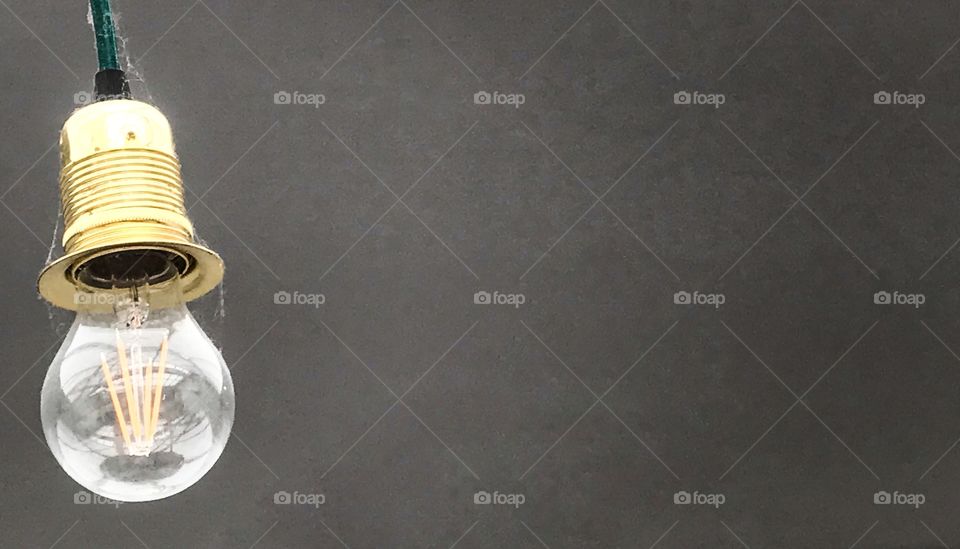 Light bulb against grey background