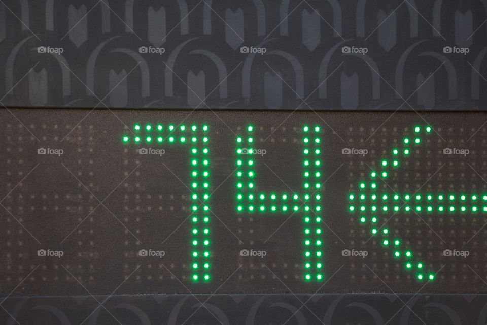 A sign of number 74 showing the direction in a car parking