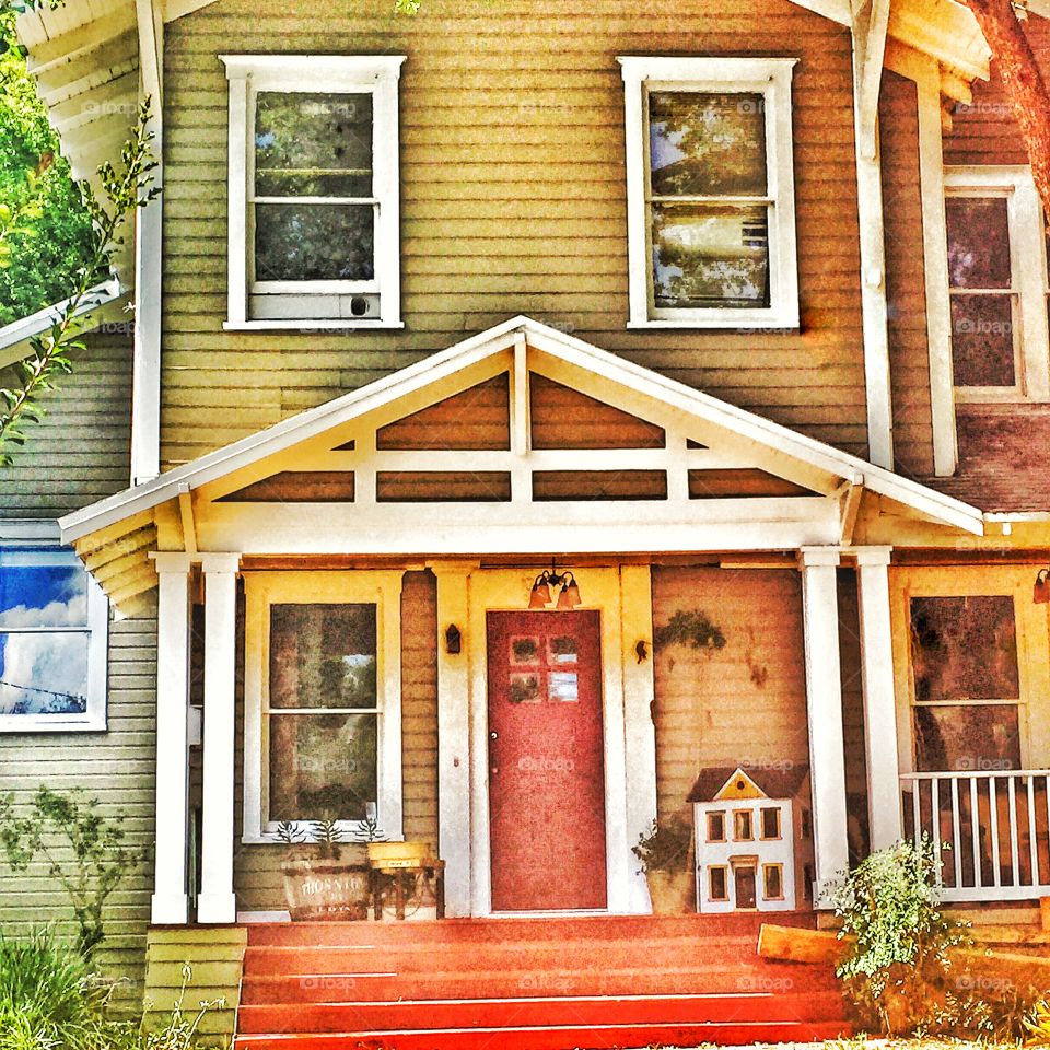 Doll house. A doll house sitting on the front porch