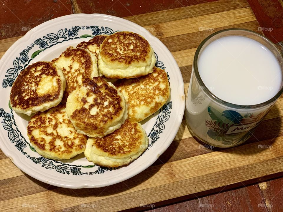 cottage cheese pancakes with milk for breakfast. Tasty and healthy.