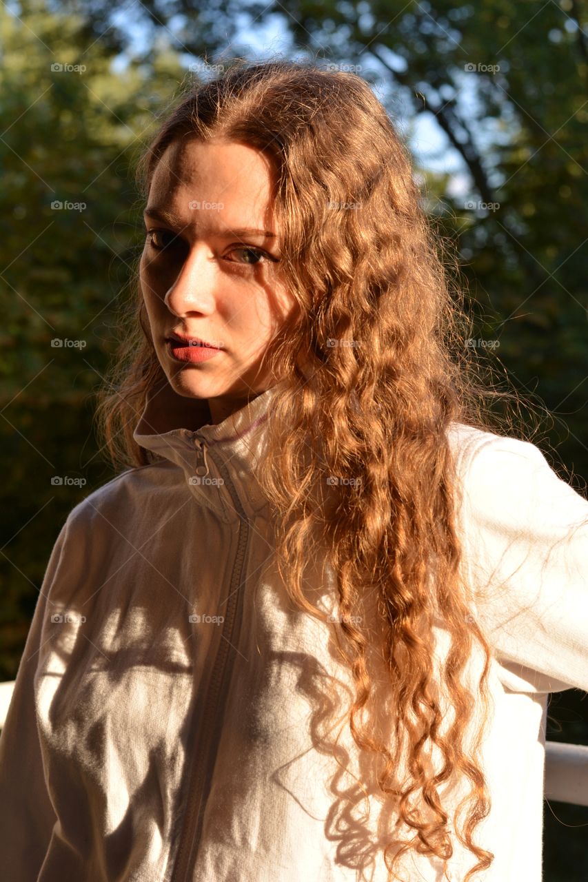 brunette girl beautiful portrait in sunlight outdoor