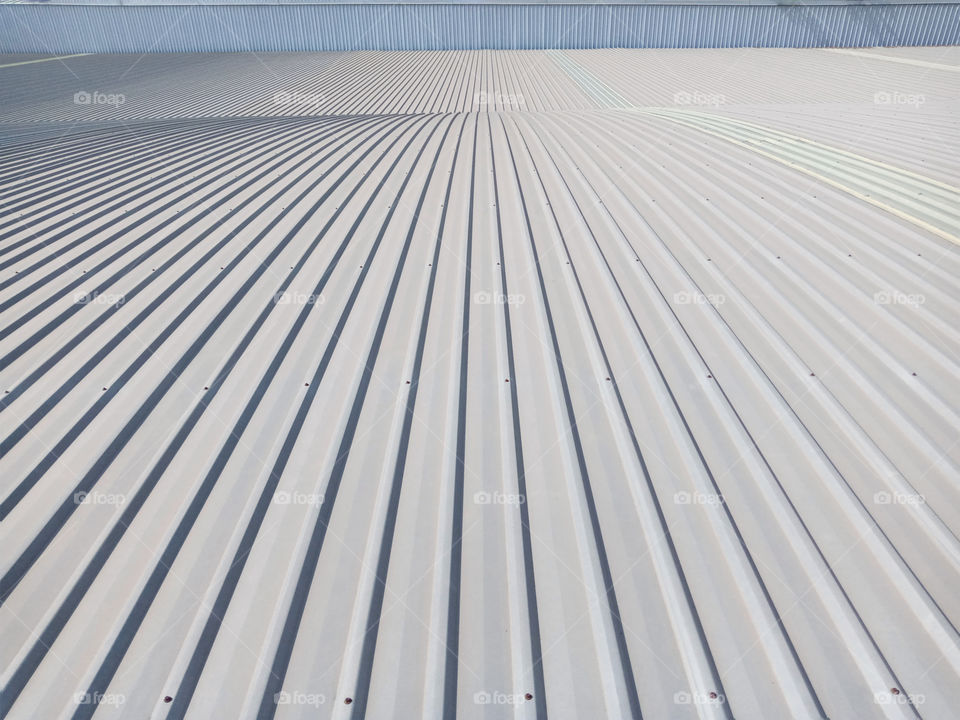 Photograph of a grey metal sheet part of a roof.