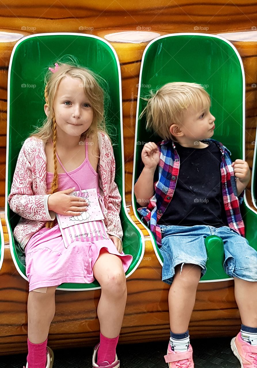 Two kids waiting for the ride to start