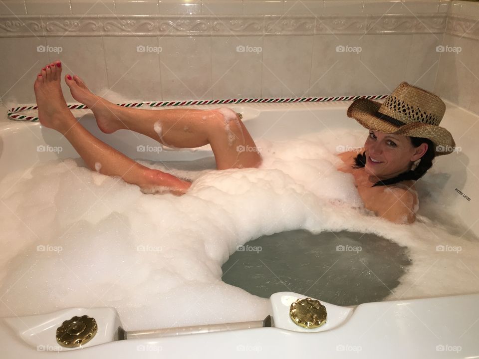 Woman bathing in tub