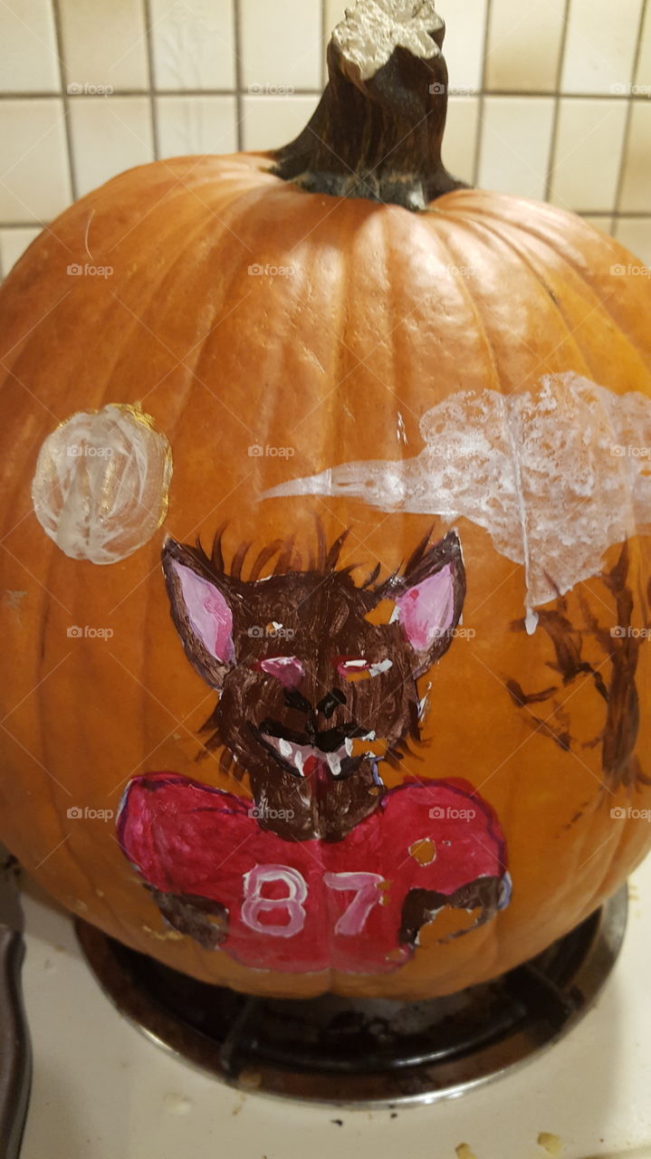 The third side of the pumpkin that was painted is another Chiefs player who's jersey # is 84. He is portrayed as the werewolf with a full moon, clouded sky, bats and a spooky tree in his background.