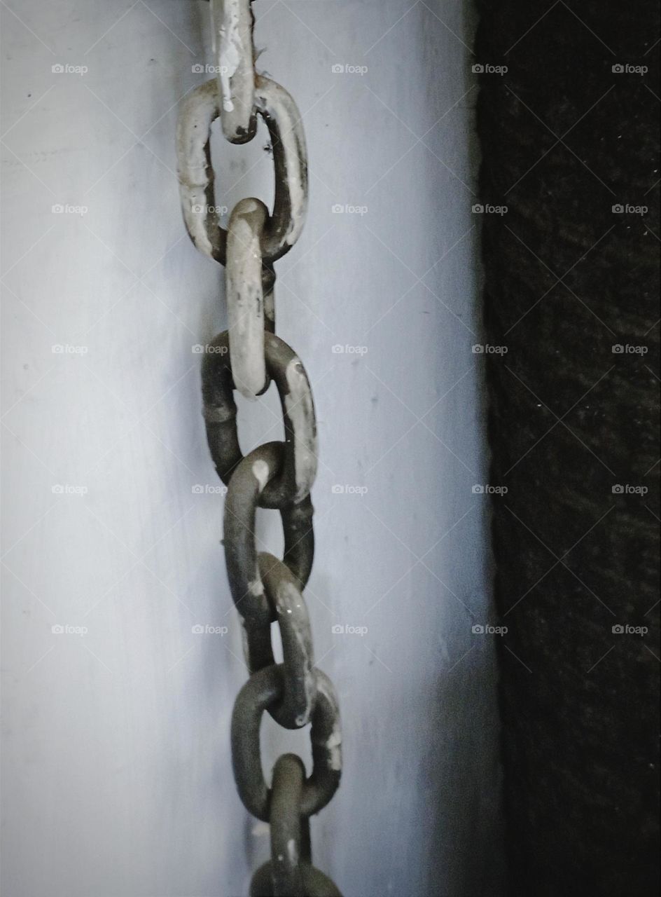 Chain hanging on the wall...