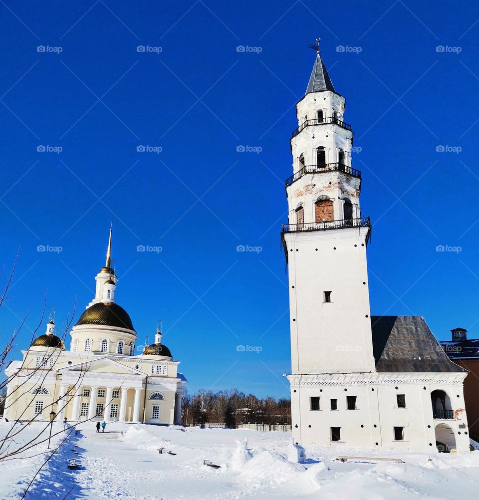 Church in Russia, temple, bell tower, tower, white building, winter, snow, snowdrifts. Russia. Sky. Architecture.