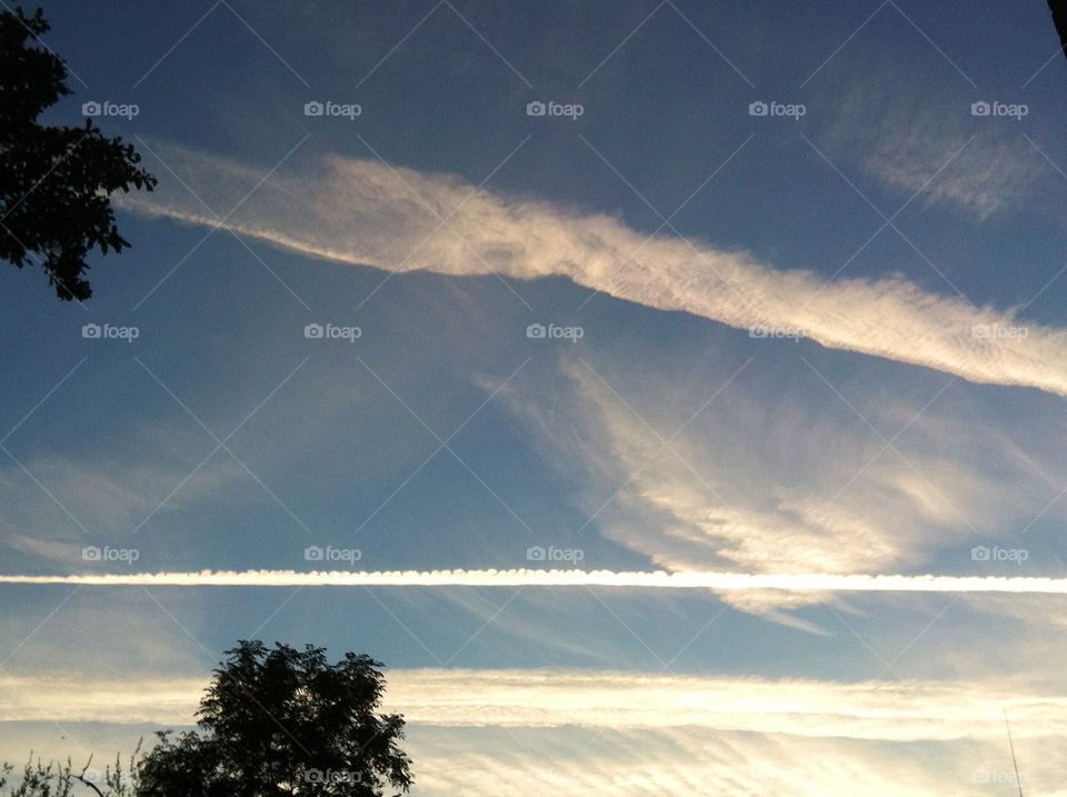 An aeroplane's vapour trail at the end of the day