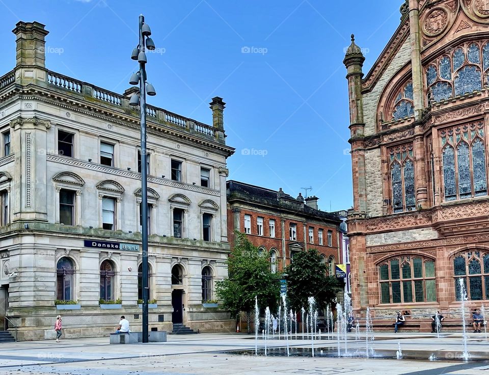 Fountains erupt sporadically in the plaza outside the Guildhall in Derry, Northern Ireland.