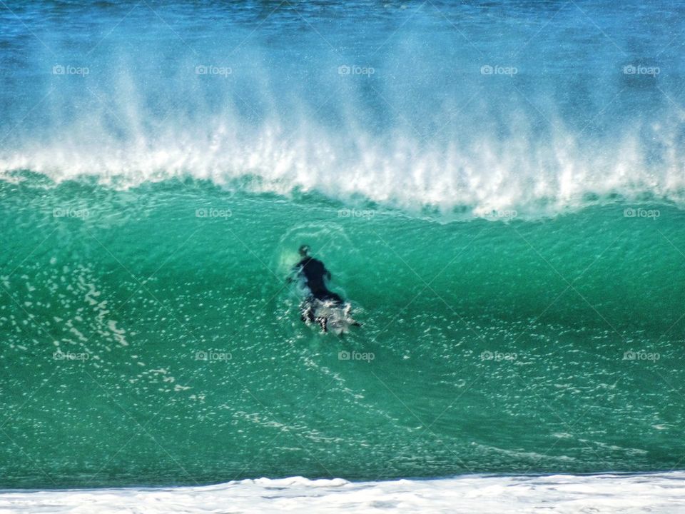 Surfer Paddling Into A Monster Wave. Surfer Hitting A Giant Wave